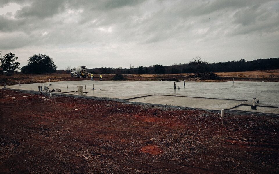 Fresh slab foundation poured over stabilized soil