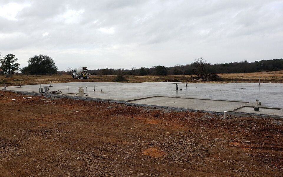 Freshly poured building pad on a prepared lot